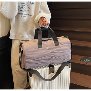 Detail of the water-resistant nylon duffel bag fabric and elegant pleated design