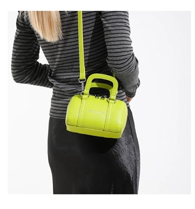 Detailed back view of a fluorescent green mini pillow bag featuring litchi leather texture