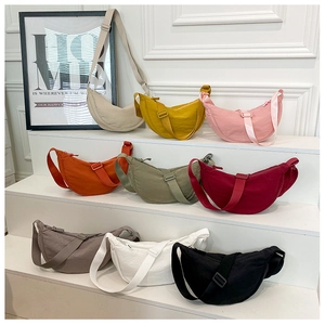 Detailed display of crescent nylon crossbody bags in nine colors on tiered stands