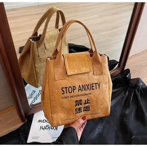 Detail showing the waterproof DuPont paper tote bag with STOP ANXIETY printed text