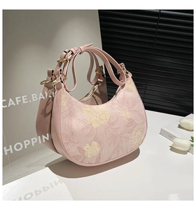 Detail of pink floral crescent handbag with premium matte leather and golden hardware