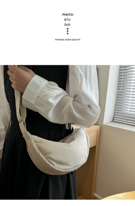 Close-up of beige nylon crescent moon crossbody bag with wide shoulder strap details