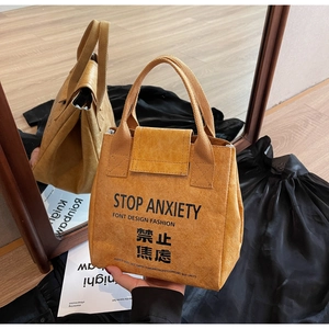 Detail of waterproof Dupont paper handbag with Stop Anxiety text and wrinkled texture