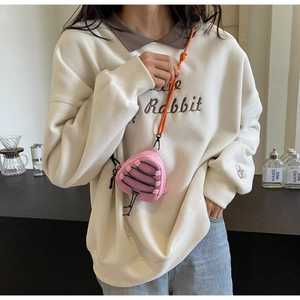 Pink triangular mesh mini bag with orange climbing rope strap worn by a model