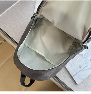 Detail of the gray backpack main compartment with durable inner lining and organizer pocket