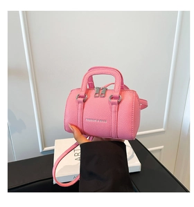 Gros plan du mini sac boston rose en cuir texturé litchi avec finitions argentées