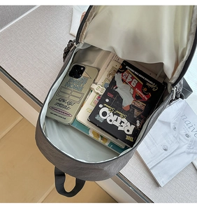 Detailed interior view of a large capacity grey nylon backpack showing storage compartments
