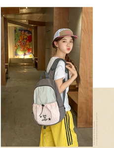 Detailed view of canvas backpack featuring a three-color splice design and drawstring pocket