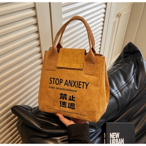 Close-up of waterproof Tyvek lunch bag featuring STOP ANXIETY printed text and handle