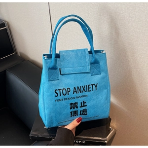 Close-up of waterproof DuPont paper bag with Stop Anxiety slogan in blue finish
