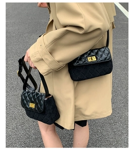 Close-up of black quilted crossbody bags with gold metallic twist locks and sleek textures