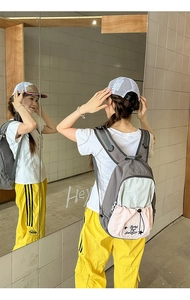 Detail of multi-color casual backpack with star embroidery and zipper pocket