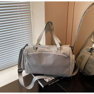 Detailansicht der Sporttasche mit Waffelgewebe-Vordertasche und Stickerei-Details