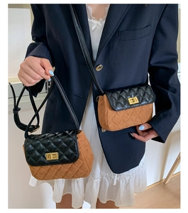 Detail of quilted leather crossbody bag with brown suede and golden turn-lock closure