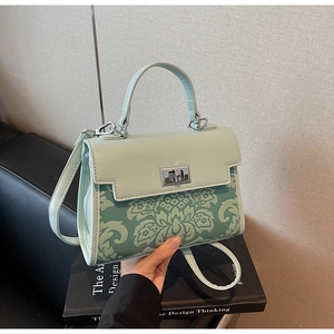 Detail of mint green vintage floral bag with silver twist lock and slim shoulder strap