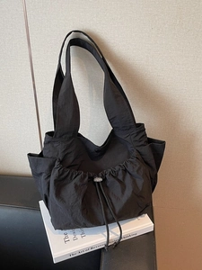 Large black drawstring tote bag in nylon fabric for casual daily commute wear