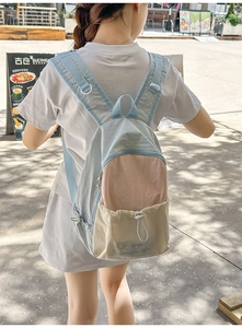 Lifestyle view of a lightweight blue and pink color-block backpack for students