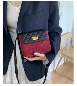 Detail of quilted two-tone crossbody bag with gold turn-lock and premium suede texture