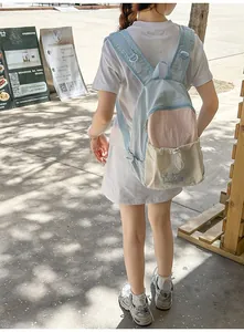 Outdoor view of a pastel color-block school backpack with light blue and pink panels