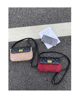 Flat lay of quilted crossbody bags in beige and burgundy with gold twist locks