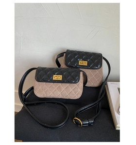 Detail of the diamond-quilted contrast crossbody bag with a vintage gold twist-lock closure