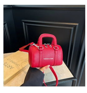 Détail du mini sac polochon rouge motif lychee avec double zip et bandoulière réglable