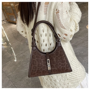 Brown leopard print bucket bag featuring a velvety texture and elegant silver buckle detail