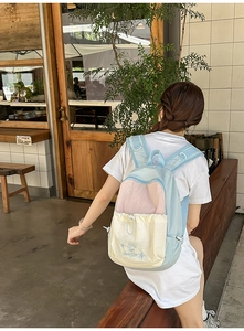 Detail of a pastel blue, pink, and beige nylon backpack with Soul for Daydream embroidery
