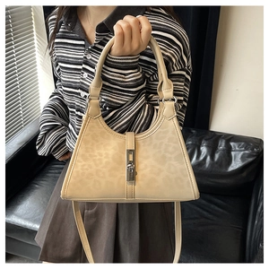 Detailed close-up of leopard print bucket bag with silver metal buckle and top handle