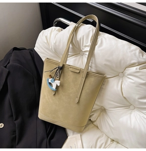 Detail of olive khaki large tote bag in matte faux leather with horse charm