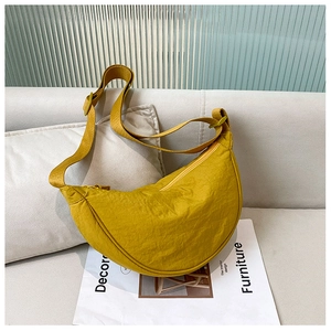 Detail of ginger yellow nylon moon bag with smooth zipper and wide adjustable strap