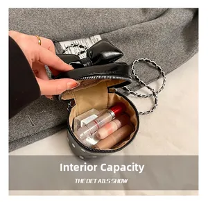 Internal capacity of mini polka dot bow bag showing storage for lipsticks and makeup