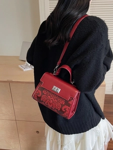 Vintage red leather handbag with floral embossing and silver rotating lock for women