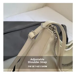 Detail of adjustable strap with silver buckle on beige large capacity tote bag