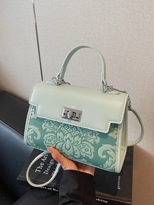 Chic mint green crossbody bag with floral embossing and silver lock for women
