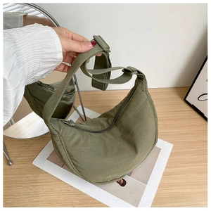 Olive green nylon crescent shoulder bag detail with wide adjustable strap and zipper closure
