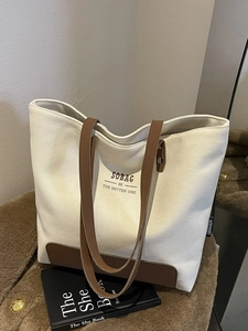 Minimalist canvas tote bag with brown leather trim and SOBAG logo for daily commute