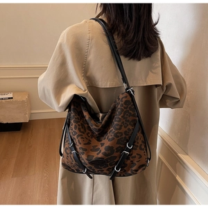 Leopard print hobo bag worn with beige trench coat for a stylish commuter look