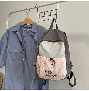 Detail of color-block backpack with drawstring pocket and Good for daytrip text