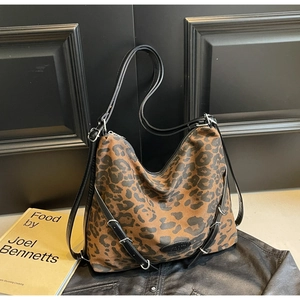 Detail of leopard print hobo bag with silver hardware rings and sleek black straps