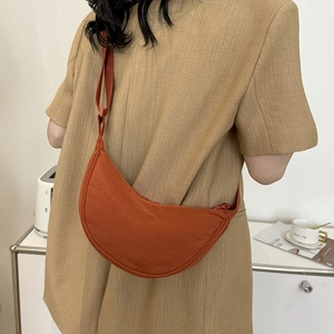Japanese style orange nylon crescent crossbody bag with adjustable wide shoulder strap
