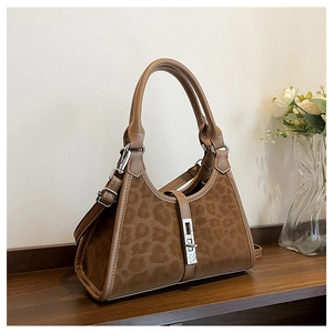 Close-up of leopard print bucket bag with silver metal lock and leather handle details