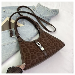 Detail of leopard print bucket bag with silver metal swivel lock and faux fur texture