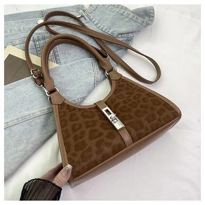 Detail shot of brown leopard print bucket bag with silver rotating lock and leather trim
