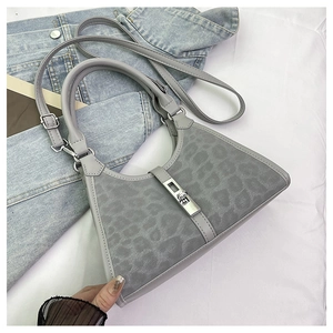 Top view of a grey leopard print bucket bag with silver buckle and adjustable strap