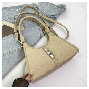 Detailed view of leopard print bucket bag with silver metal twist lock and dual straps