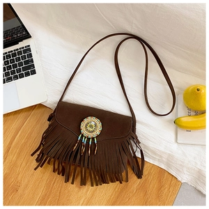 Close-up of bohemian dark brown fringe crossbody bag with colorful beaded ornament