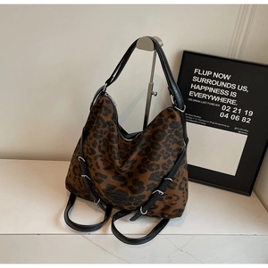 Detailed view of leopard print hobo bag with leather strap and metal buckle hardware