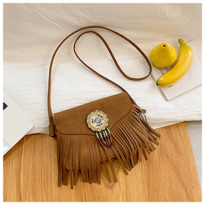 Detail of bohemian brown suede crossbody bag with colorful weave and tassel fringe