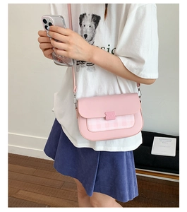Détail du sac à bandoulière rose en cuir PU avec rabat à carreaux et boucle élégante